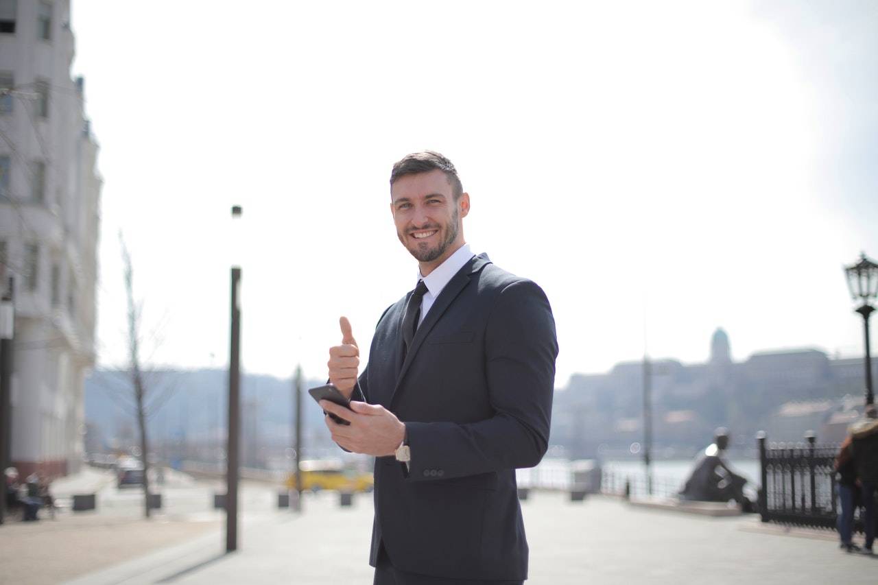 Guy in a suit giving a thumbs up - darren yaw cambodia